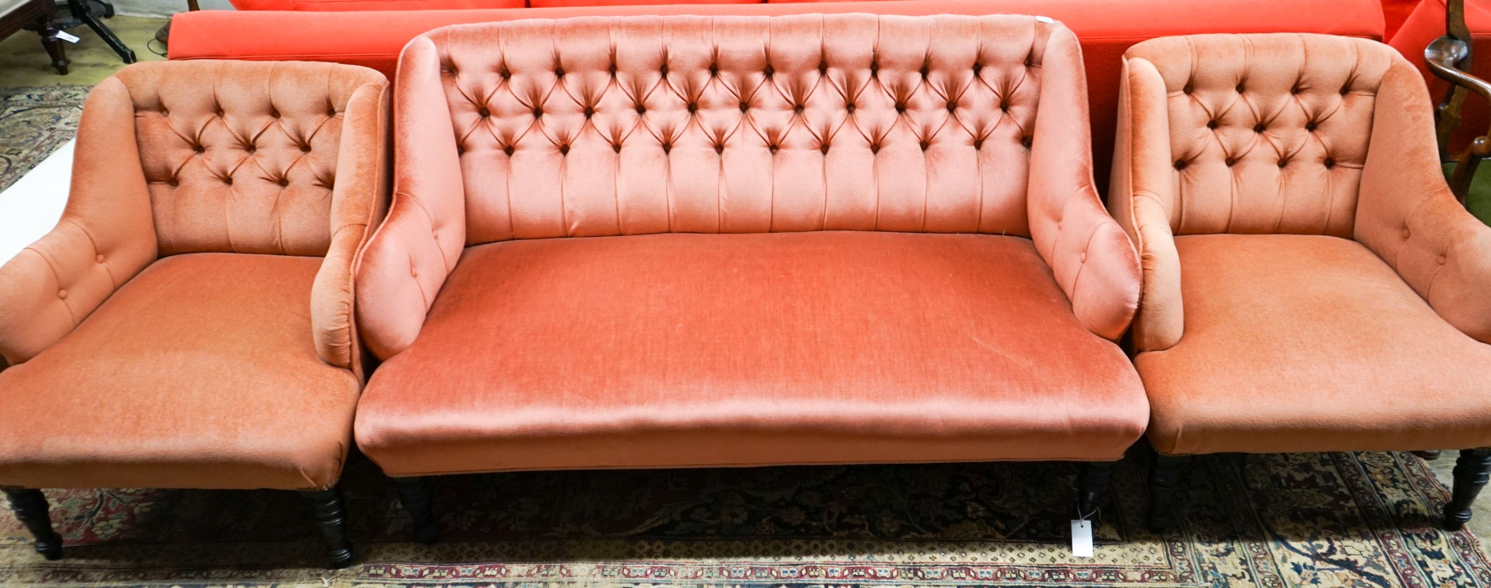 A late Victorian three piece lounge suite, upholstered in pink dralon, settee length 140cm, depth 80cm, height 78cm